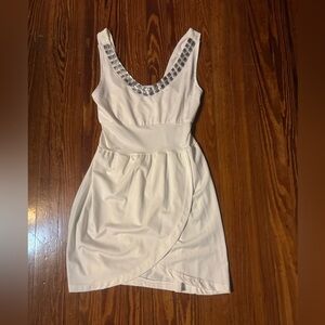 White mini dress with a tulip hem and silver sequin embellishments around